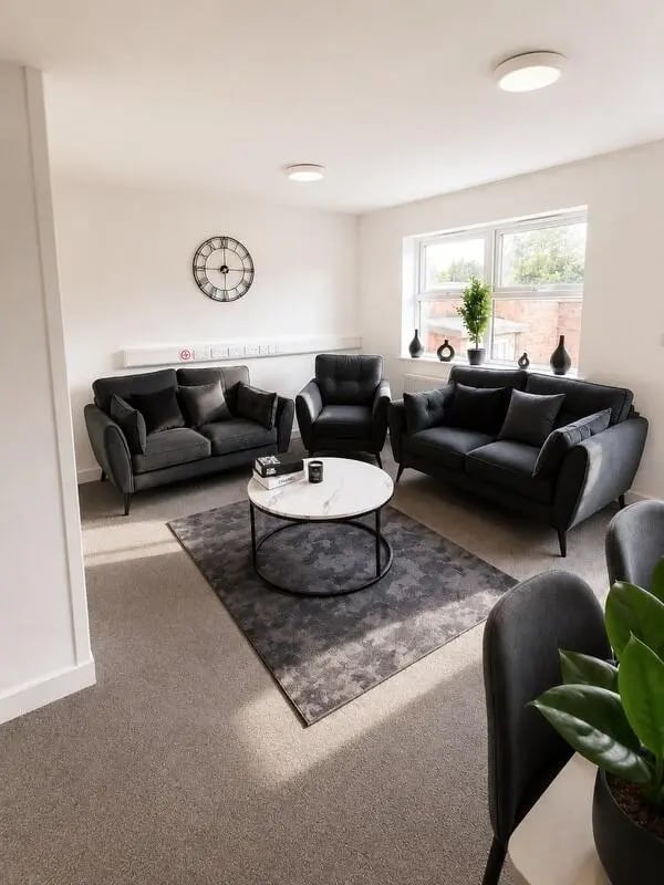 Dark sofas clock marble coffee table living room at Parham Student Village in Canterbury Student Accommodation