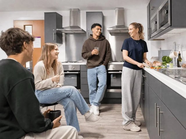 Students in modern kitchen preparing food kitchen at Unity Square in Liverpool Student Accommodation