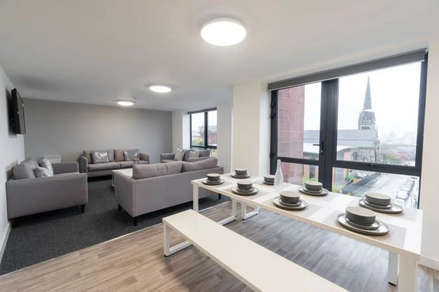 Dining table with place settings and sofas living room at Unity Square in Liverpool Student Accommodation