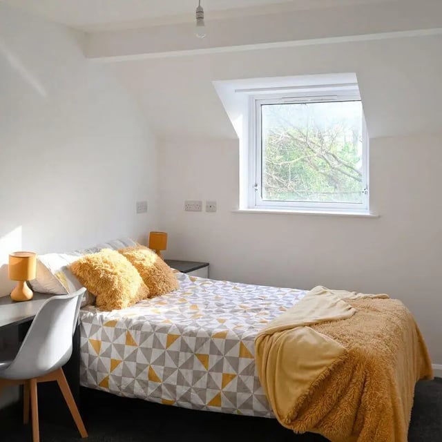 Bed desk window fluffy pillows student bedroom at Park Village in Sheffield Student Accommodation