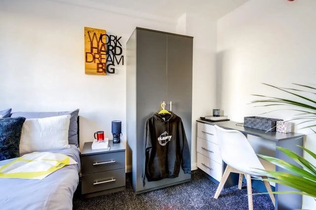 Bed, desk, wardrobe, and inspirational wall art bedroom at Clanny House in Sunderland Student Accommodation