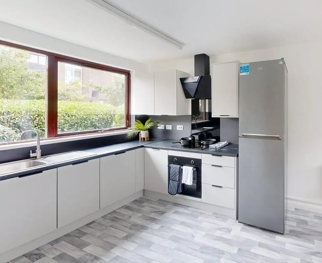 Modern student kitchen with white cabinets and fridge kitchen at Clanny House in Sunderland Student Accommodation