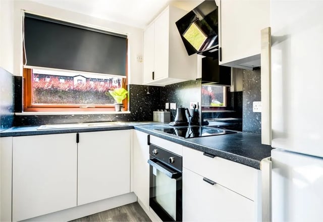 Modern white kitchen with black countertop and oven kitchen at Clanny House in Sunderland Student Accommodation