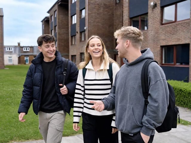 Three students walk past student housing exterior at Clanny House in Sunderland Student Accommodation