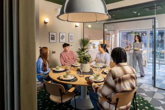 Students dining at round table kitchen interior living room at Fusion Students Liverpool in Liverpool Student Accommodation