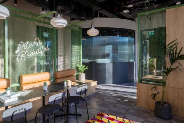 Neon sign brown booths tables chairs lounge area at Fusion Students Liverpool in Liverpool Student Accommodation