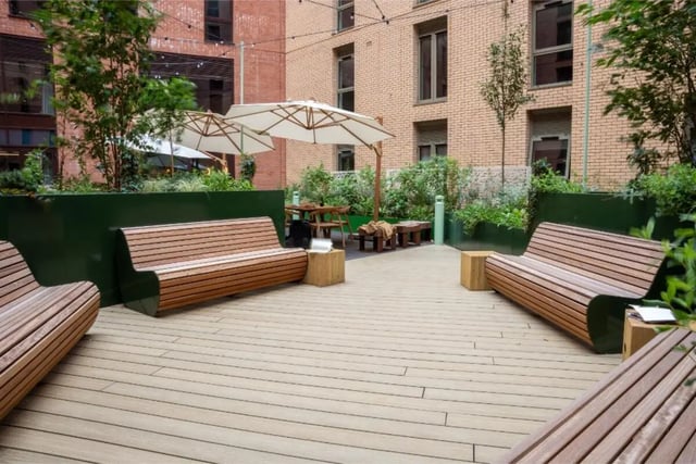 Wooden benches umbrellas and tables outdoor area exterior at Fusion Students Nottingham in Nottingham Student Accommodation