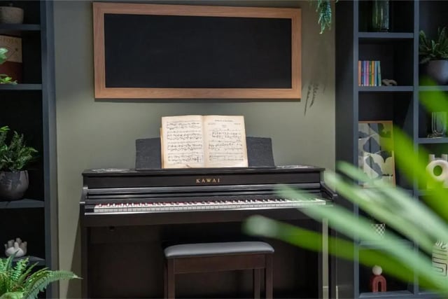 Digital piano with sheet music and stool living room at Fusion Students York in York Student Accommodation