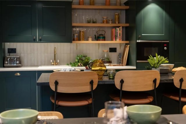 Dark green cabinets with seating and kitchenware kitchen at Fusion Students York in York Student Accommodation
