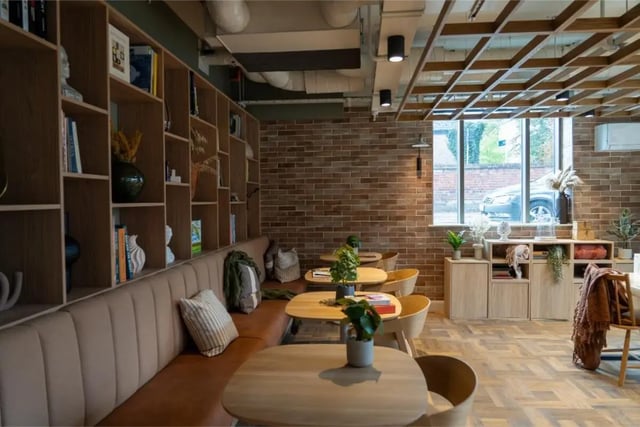 Bookshelf seating tables and plants common area at Fusion Students York in York Student Accommodation