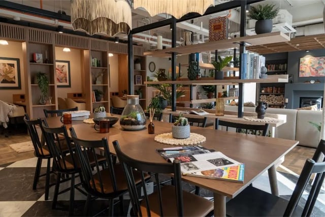 Dining table chairs books plants decor communal area at Fusion Students York in York Student Accommodation