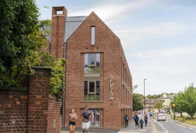 Brick building with windows and people walking Exterior at Fusion Students York in York Student Accommodation