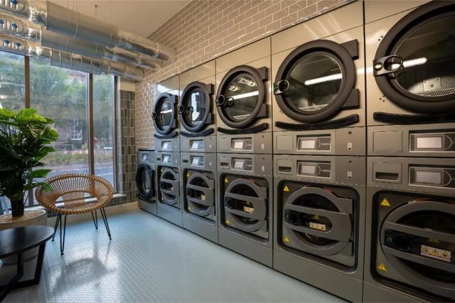 Stacking washing machines with seating area Laundry room at Fusion Students York in York Student Accommodation