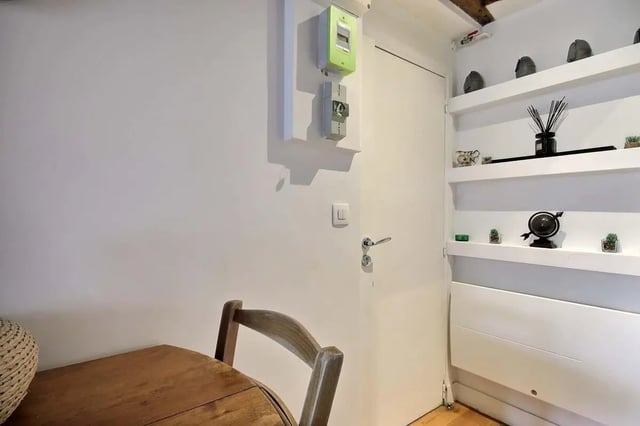 Wooden table chair and white door Interior at Studio in Rue de Bourgogne, 75007 Paris, France in Paris Student Accommodation