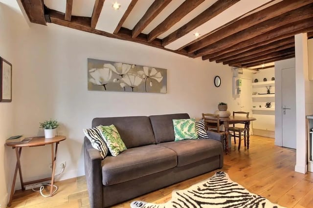 Sofa dining table and artwork living area at Studio in Rue de Bourgogne, 75007 Paris, France in Paris Student Accommodation