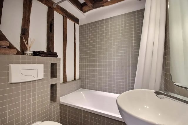 Toilet sink bathtub shower curtain bathroom at Studio in Rue de Bourgogne, 75007 Paris, France in Paris Student Accommodation