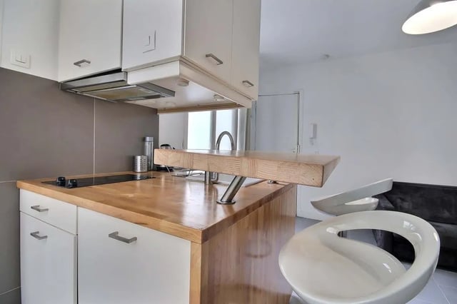 Modern kitchen counter with induction hob and stools kitchen at Apartment in Rue Keller, 75011 Paris, France in Paris Student Accommodation