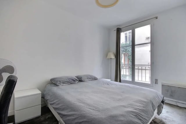 Bed dresser fan window and radiator bedroom at Apartment in Rue Keller, 75011 Paris, France in Paris Student Accommodation