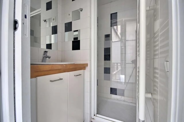 Sink cabinets tiled wall shower and bathtub bathroom at Apartment in Rue Keller, 75011 Paris, France in Paris Student Accommodation