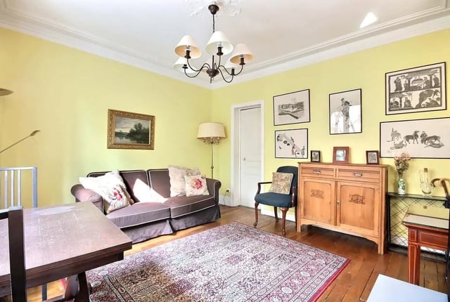 Sofa cabinet chair rug paintings living room at Apartment in Rue Caulaincourt, 75018 Paris, France in Paris Student Accommodation