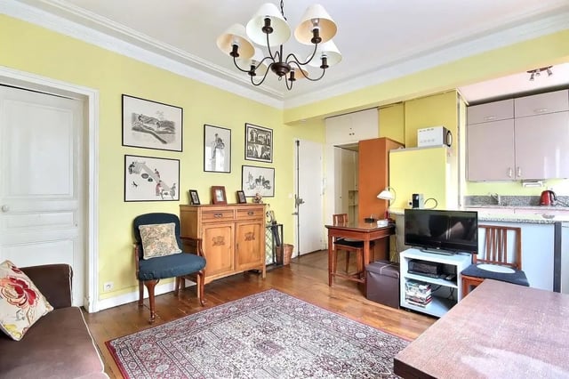 Sofa rug chair cabinet TV dining area living room at Apartment in Rue Caulaincourt, 75018 Paris, France in Paris Student Accommodation