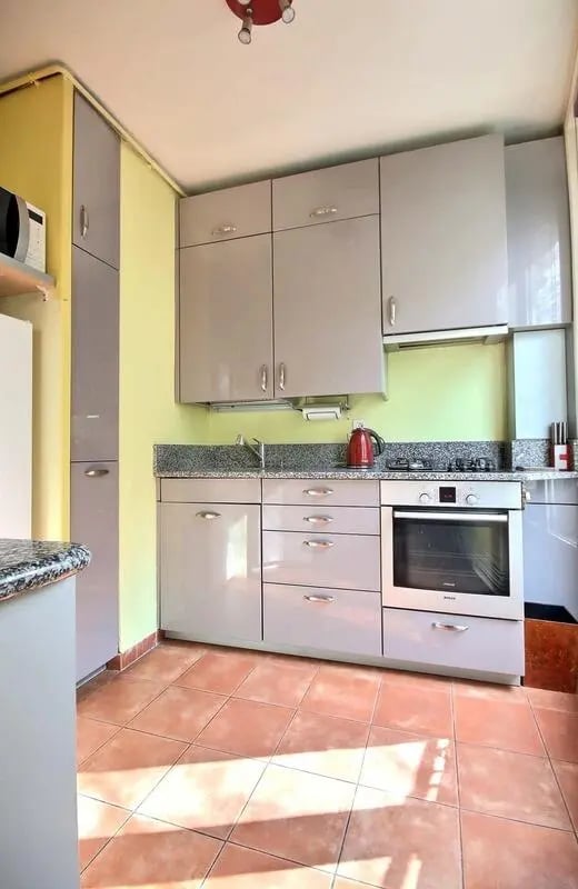 Gray cabinets oven kettle and microwave kitchen at Apartment in Rue Caulaincourt, 75018 Paris, France in Paris Student Accommodation