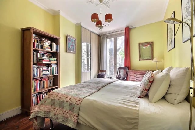 Bed bookshelf pillows lamp wardrobe bedroom at Apartment in Rue Caulaincourt, 75018 Paris, France in Paris Student Accommodation