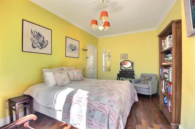 Bed with patterned quilt and artwork Bedroom at Apartment in Rue Caulaincourt, 75018 Paris, France in Paris Student Accommodation