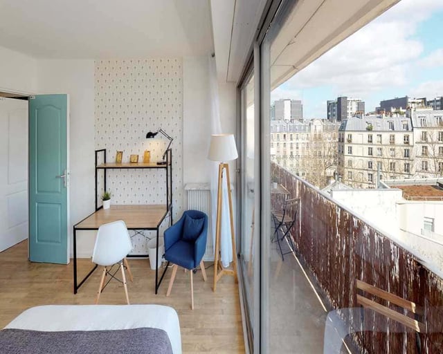 Desk chairs lamp and balcony student room at Room in 33 Rue d'Hautpoul, 75019 Paris, France in Paris Student Accommodation