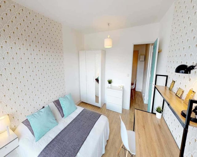 Bed with blue pillows wardrobe white dresser desk bedroom at Room in 33 Rue d'Hautpoul, 75019 Paris, France in Paris Student Accommodation