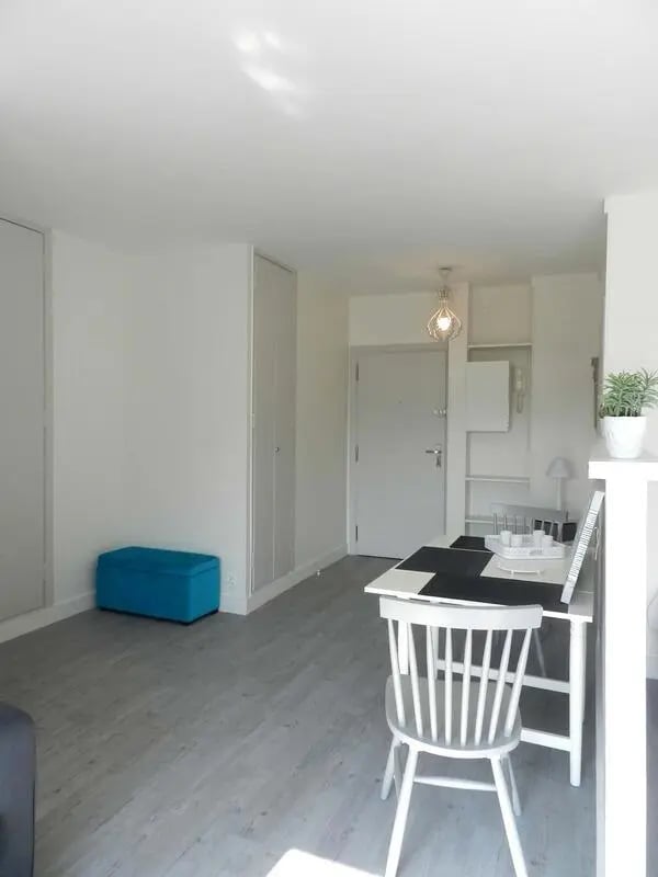 Blue ottoman dining table and chair living area at Studio in Rue Lecourbe, 75015 Paris, France in Paris Student Accommodation