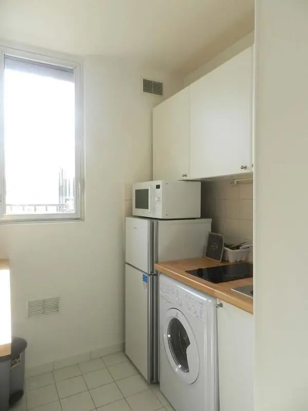 Microwave refrigerator washing machine kitchen at Studio in Rue Lecourbe, 75015 Paris, France in Paris Student Accommodation