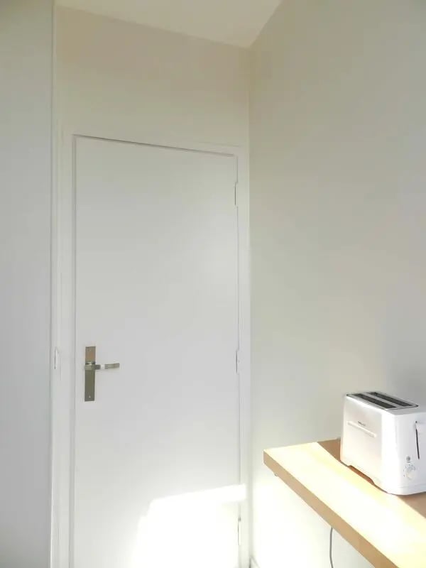 White door with silver handle and toaster Kitchen at Studio in Rue Lecourbe, 75015 Paris, France in Paris Student Accommodation