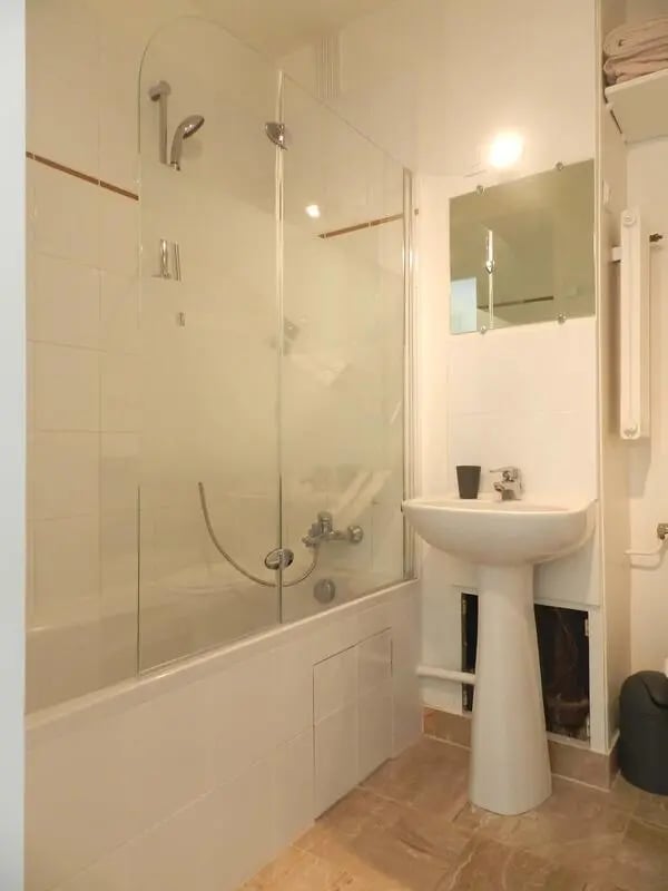 Shower bathtub sink mirror trash bin bathroom at Studio in Rue Lecourbe, 75015 Paris, France in Paris Student Accommodation