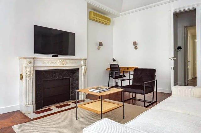 Fireplace TV desk chair living room at Apartment in 2 Rue de Miromesnil, 75008 Paris, France in Paris Student Accommodation
