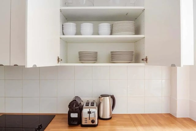 Stacked plates bowls coffee machine toaster kettle kitchen at Apartment in 2 Rue de Miromesnil, 75008 Paris, France in Paris Student Accommodation