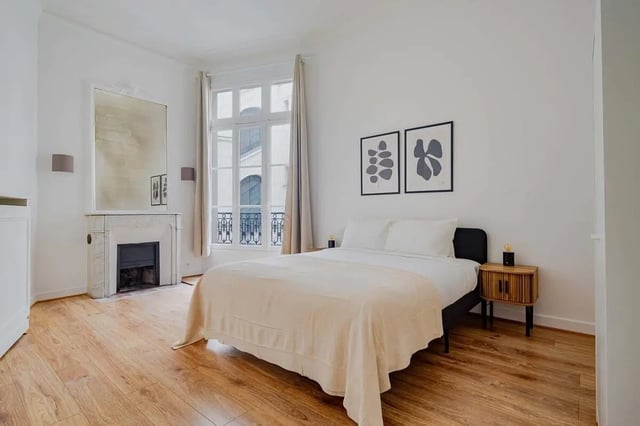 Bed fireplace and artwork bedroom at Apartment in 2 Rue de Miromesnil, 75008 Paris, France in Paris Student Accommodation