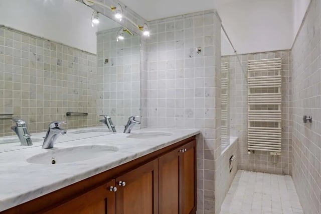 Double vanity sinks with marble top and wooden cabinet Bathroom at Apartment in 2 Rue de Miromesnil, 75008 Paris, France in Paris Student Accommodation