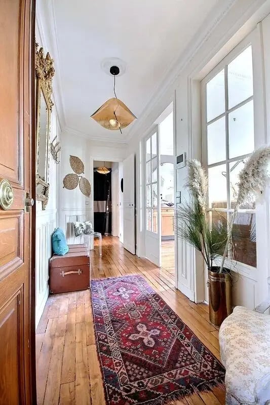 Hallway with vintage trunk patterned rug entryway at Apartment in Rue Régis, 75006 Paris, France in Paris Student Accommodation