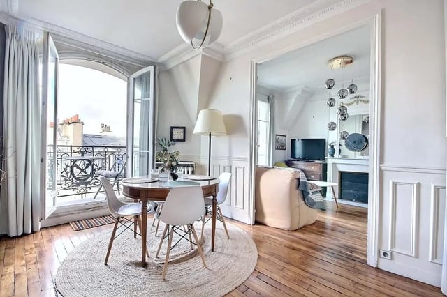 Round dining table chairs balcony french doors living room at Apartment in Rue Régis, 75006 Paris, France in Paris Student Accommodation