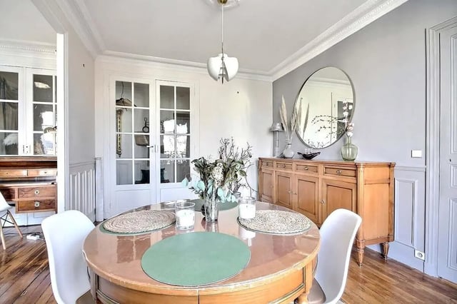 Round table chairs sideboard mirror doors dining room at Apartment in Rue Régis, 75006 Paris, France in Paris Student Accommodation