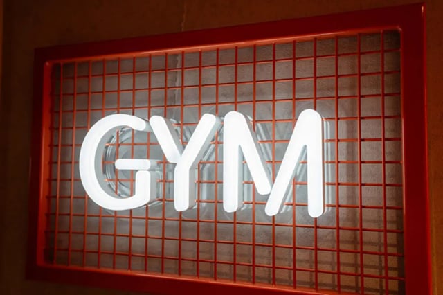 White neon GYM sign on orange grid gym at Skyline in Bournemouth Student Accommodation