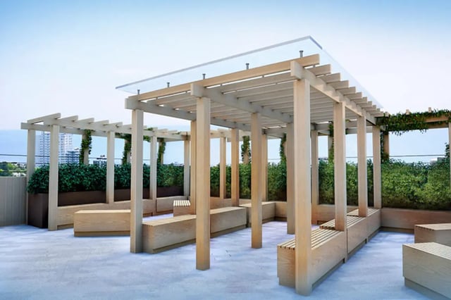 Wooden pergolas and benches on rooftop terrace exterior at Skyline in Bournemouth Student Accommodation
