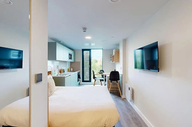 Bed kitchen table chairs television studio apartment at Burnsall House in Coventry Student Accommodation
