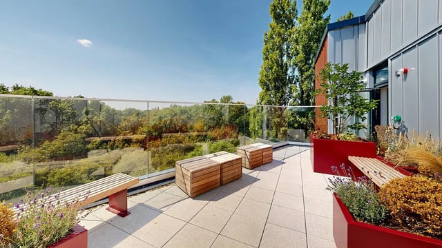 Wooden benches planters balcony overlooking trees exterior at Burnsall House in Coventry Student Accommodation