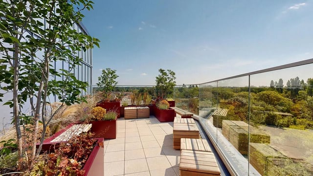 Potted plants wooden benches outdoor seating area terrace at Burnsall House in Coventry Student Accommodation