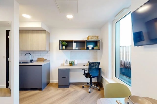 Desk chair plants kitchen and window study area at Bridgeside in Nottingham Student Accommodation