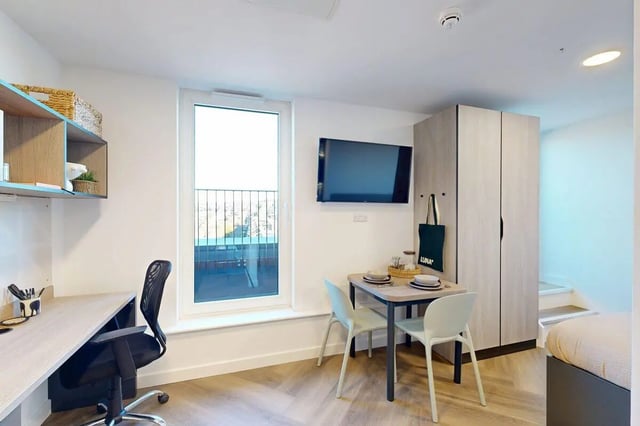 Desk chair table TV wardrobe study area living room at Bridgeside in Nottingham Student Accommodation