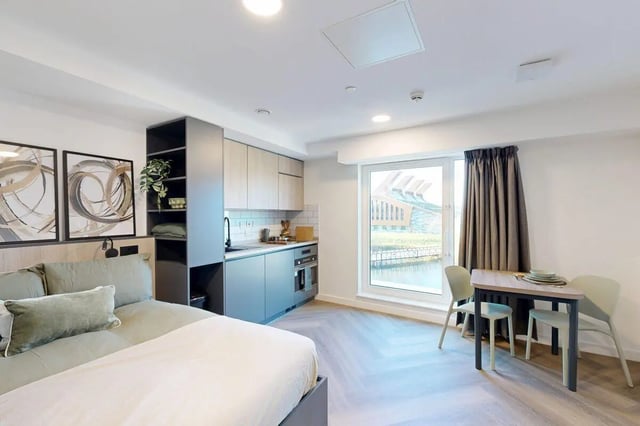 Bed kitchen dining table and chairs studio apartment at Bridgeside in Nottingham Student Accommodation