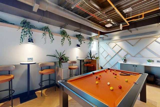 Pool table bar stools and plants common area at Bridgeside in Nottingham Student Accommodation